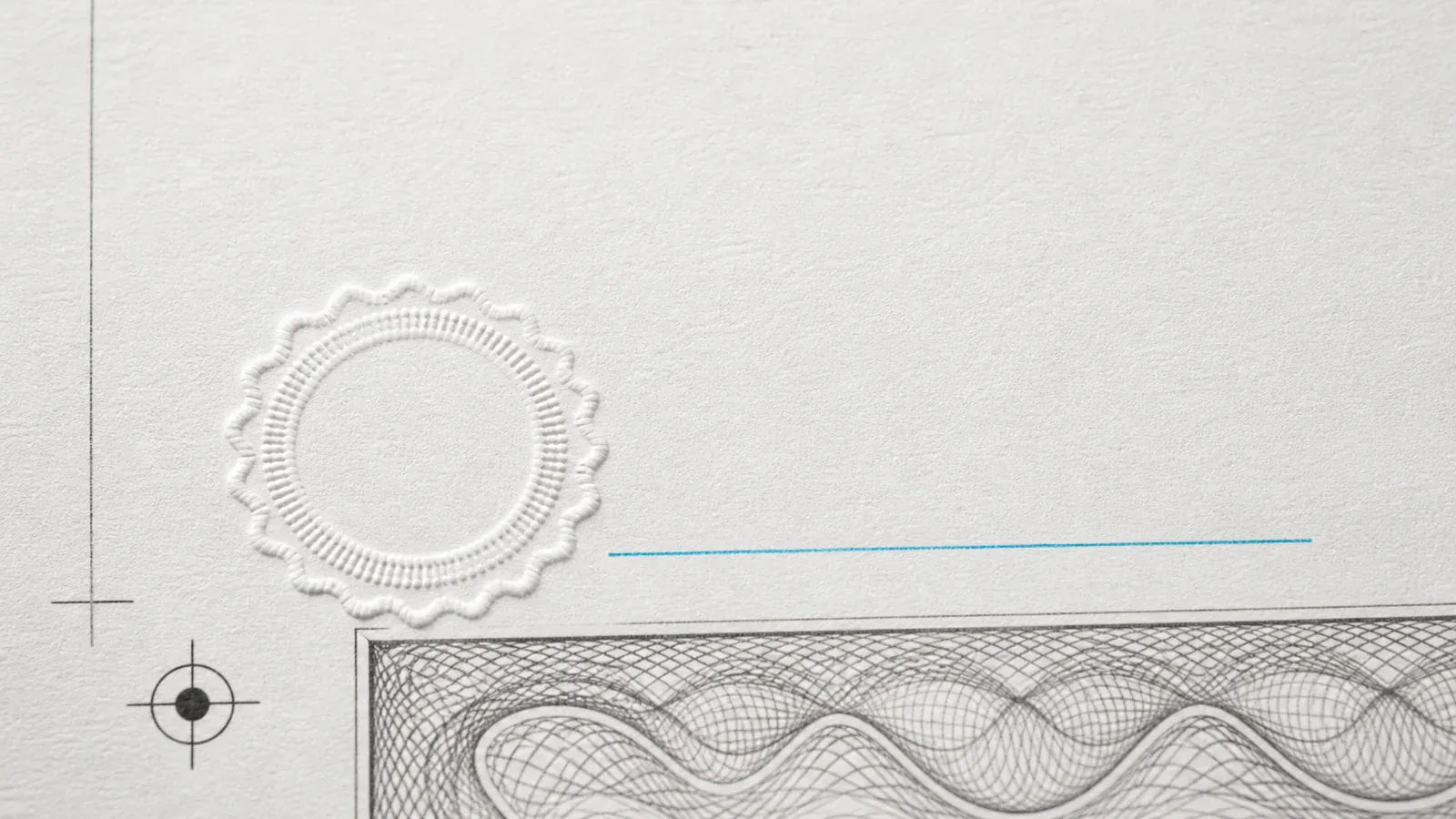 Macro detail of a printed agreement with an embossed dry seal, guilloche border, countersign rule, and registration target.